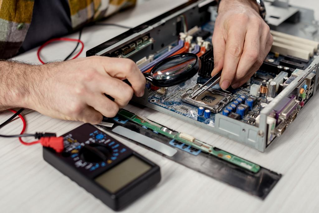 stock-photo-cropped-image-hands-fixing-motherboard